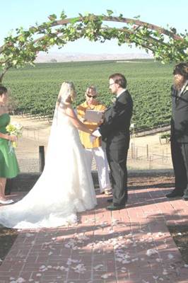 Mario performs the ceremony as matron of honor Taunya Rose and best man Matt Lydon observe 
