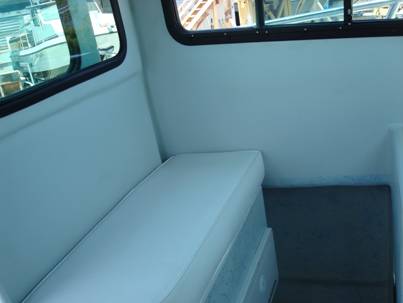 Side passenger seat with storage below