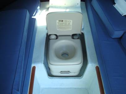 The porta-potti fits in a compartment between the bunks
