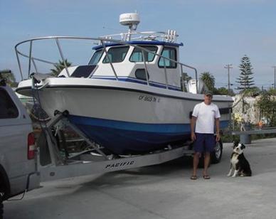 Tony Hotchkiss with his boat and his dog, Oso